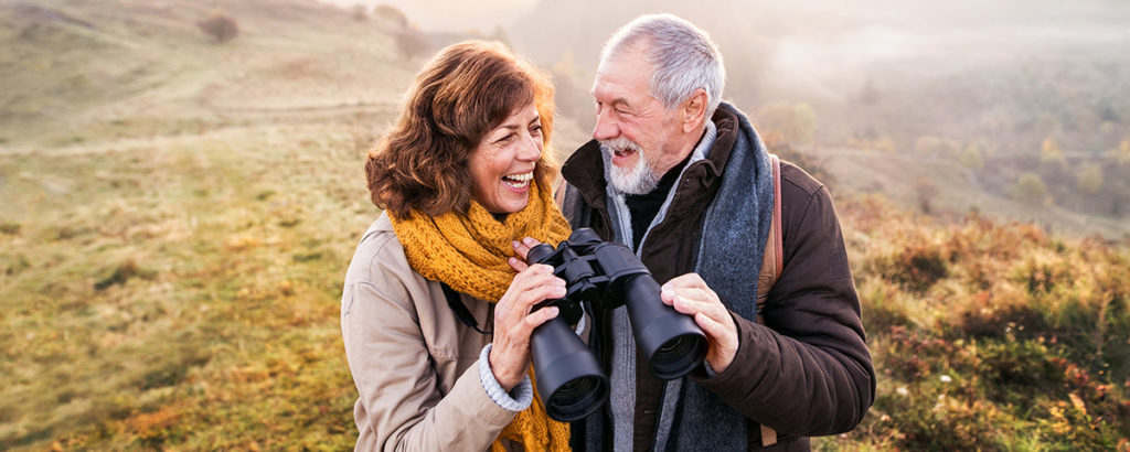 older couple outside birdwatching